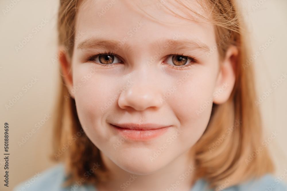 portrait of a cheerful little girl with blonde hair in a blue T-shirt. happy childhood. Emotions. portrait of a cheerful little girl with blonde hair in a blue T-shirt. happy childhood. Emotions.