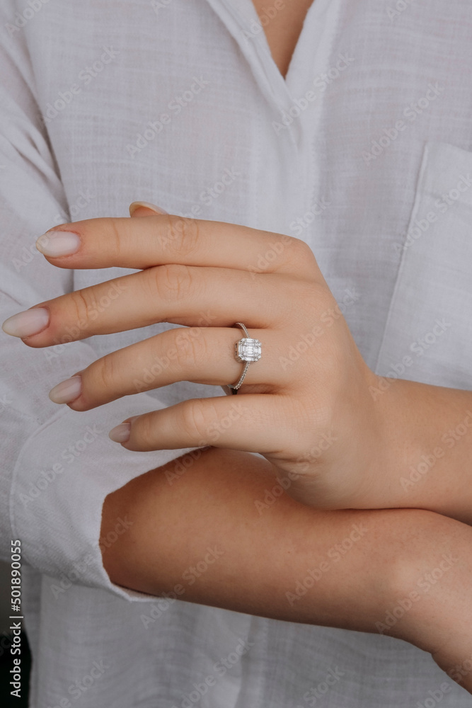 Close up of an elegant engagement diamond ring on female finger. love and wedding. Soft and selective focus. Close up of an elegant engagement diamond ring on female finger. love and wedding. Soft and selective focus.