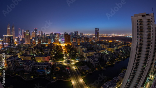 Skyscrapers in Barsha Heights district and low rise buildings in Greens district aerial night to day timelapse.