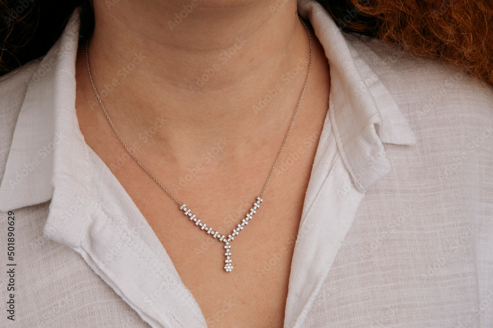 Close-up young woman wearing gold chain necklace. Modern fashion details. minimalist lifestyle