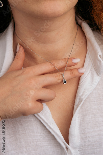 Close-up young woman wearing gold chain necklace. Modern fashion details. minimalist lifestyle © Oguz