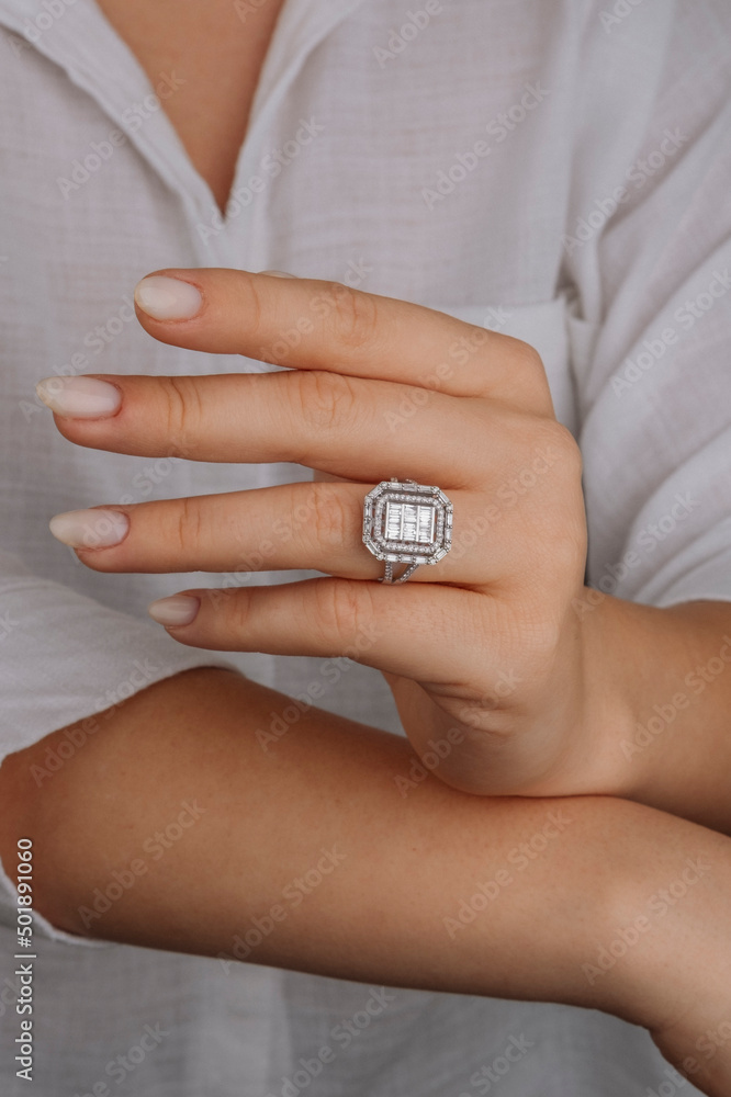 Close-up of elegant diamond ring on female finger. Love and wedding concept.Soft and selective focus. Close-up of elegant diamond ring on female finger. Love and wedding concept.Soft and selective focus.