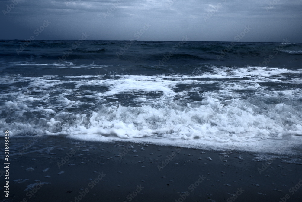 Landscape of blue ocean waves with beautiful clouds.