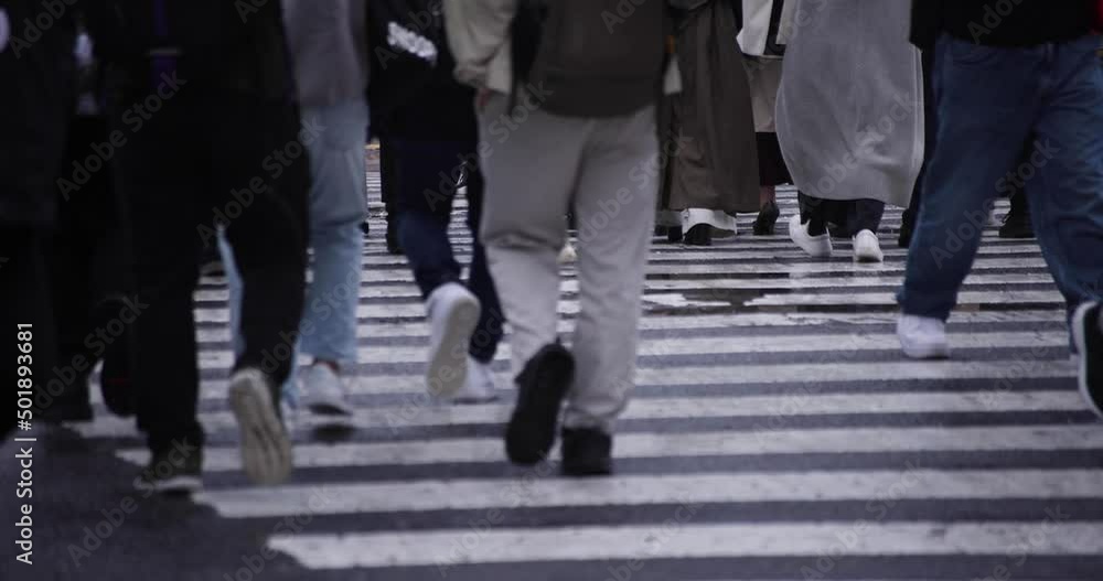 A slow motion of walking people at the crossing in Shibuya rainy day A slow motion of walking people at the crossing in Shibuya rainy day
