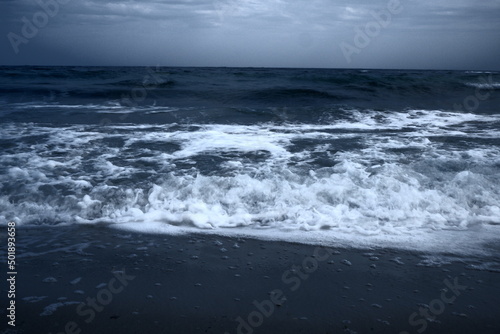 Landscape of blue ocean waves with beautiful clouds. © nagornyisergiy