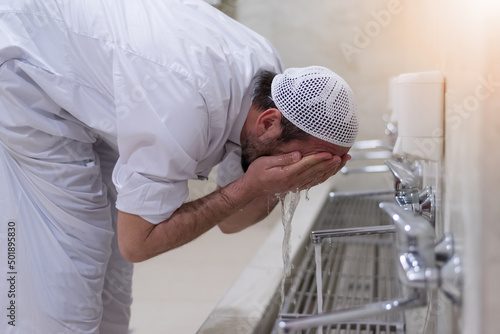 Muslim man taking ablution for prayer