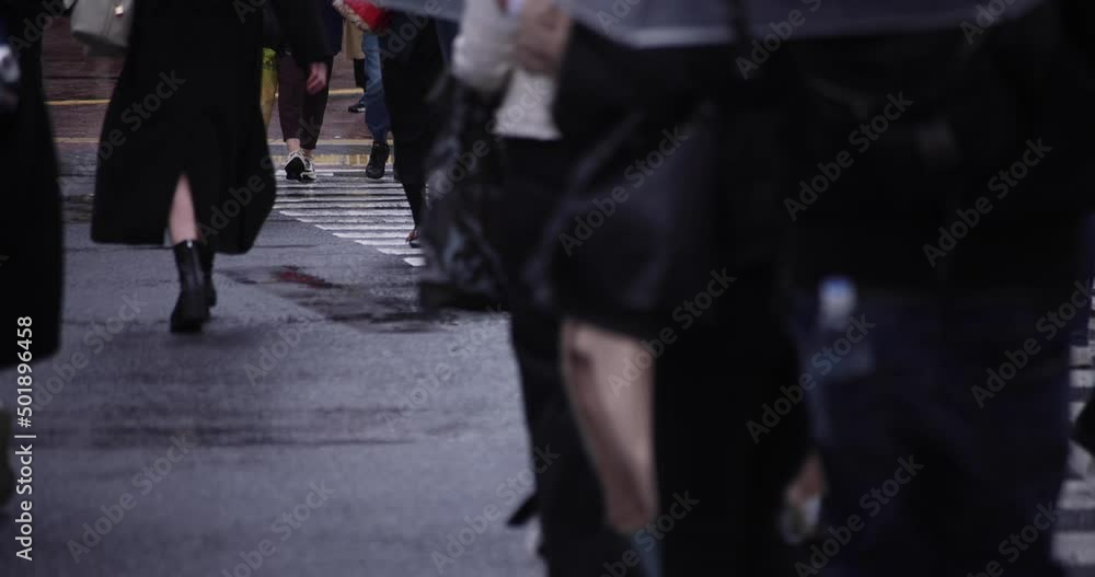 A slow motion of walking people at the crossing in Shibuya rainy day A slow motion of walking people at the crossing in Shibuya rainy day