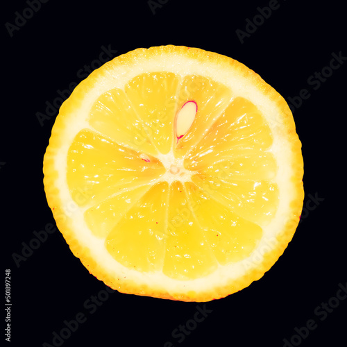 Slice of lemon on black background. Isolated object of fruit.