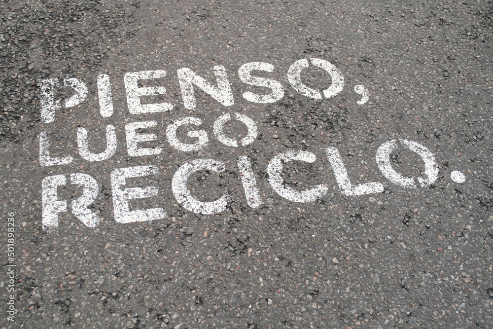I think, then I recycle. Environmentalist message painted on the street asphalt I think, then I recycle. Environmentalist message painted on the street asphalt