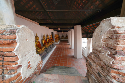Canvas Print Beside the inner wall of Wat Phutthaisawan, Ayutthaya, Thailand, there are many golden Buddha images in the posture of meditation, photographed on March 10, 2022