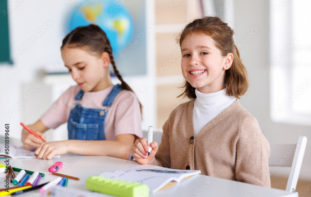 Girl drawing in notepad during lesson Girl drawing in notepad during lesson