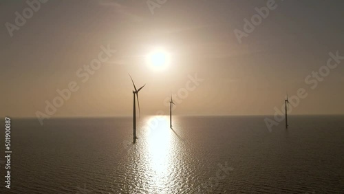 Windmill Silhouette Spinning on calm waters, scenic seascape, eolic energy Concept photo
