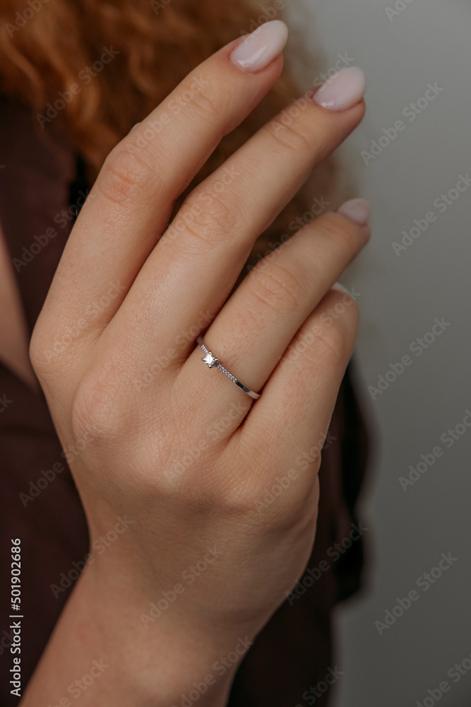 Close-up of elegant diamond ring on female finger. Love and wedding concept.Soft and selective focus. Close-up of elegant diamond ring on female finger. Love and wedding concept.Soft and selective focus.