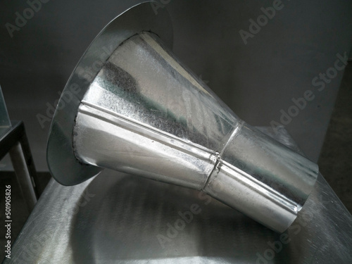 Downspout Funnel Reducers 6 inch to 3 inch for Downpipe, Galvanized steel Funnel is put on the stainless table, photo is Depth of Field style
