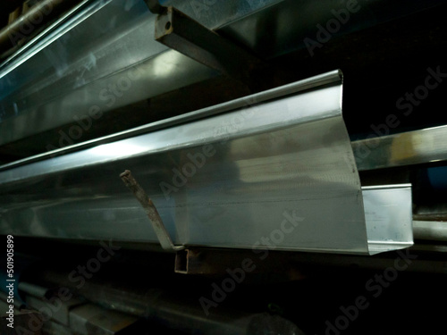 stainless steel gutters in Storage Metal Rack with Wall Mount, gutters with blurred background, photo is Depth of Field style
