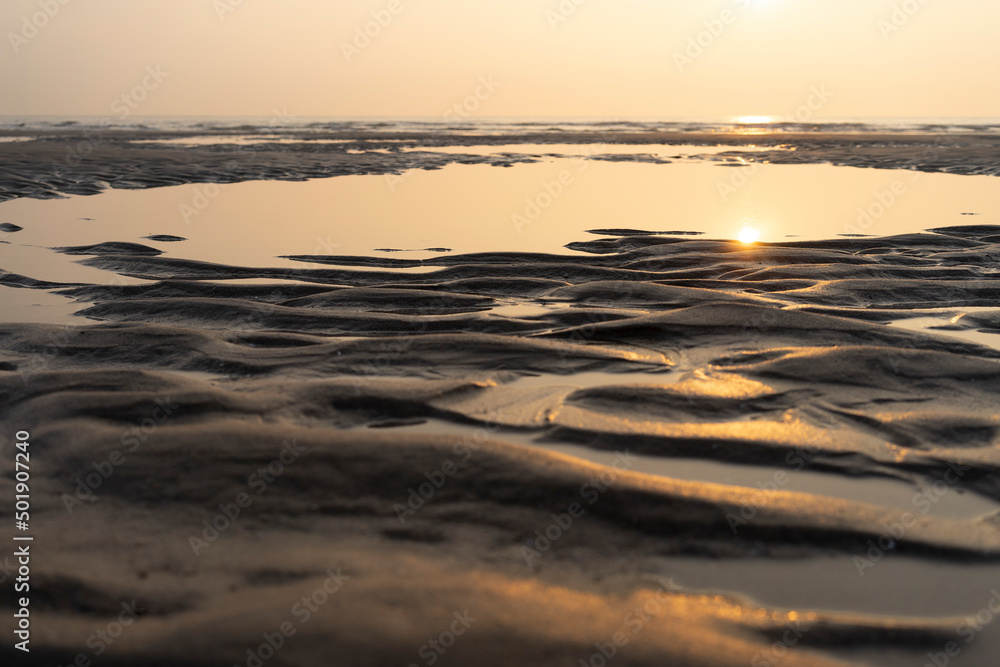 Sunset on the beach on the French opal coast with sea and sand with structures. Copy space. Horizon Sunset on the beach on the French opal coast with sea and sand with structures. Copy space. Horizon