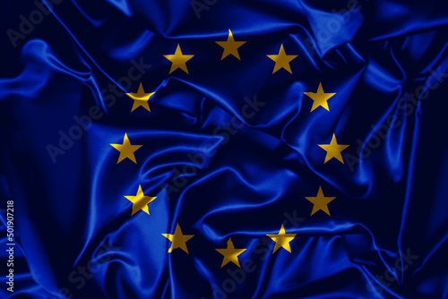 European Union flag waving in the wind. Close up of Europe banner blowing, soft and smooth silk. Cloth fabric texture ensign background. 