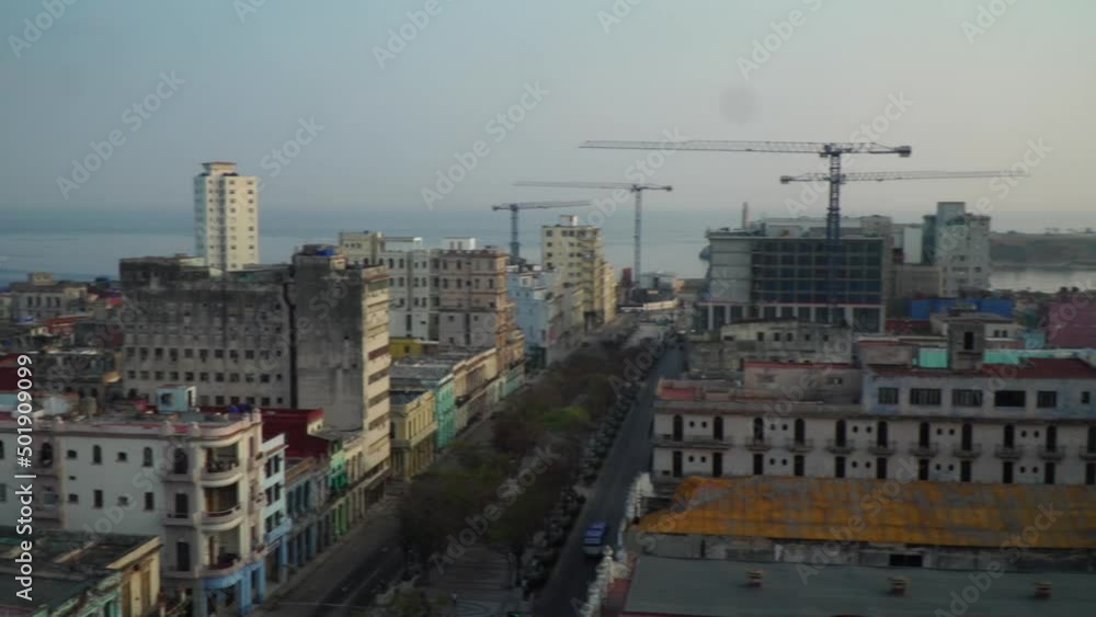 Skyline of Havana, Cuba with buildings and ocean and cranes in the background Skyline of Havana, Cuba with buildings and ocean and cranes in the background