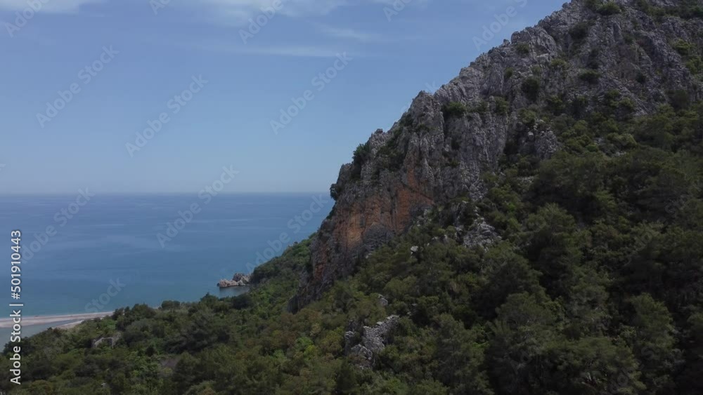 Sunny day, aerial view, flyby of points of interest, Mount Olympus, Olympus village, Turkey, Lycian Trail. Aerial drone of Cirali beach and Olympos Olimpos mountain in a beautiful day light. Kemer Sunny day, aerial view, flyby of points of interest, Mount Olympus, Olympus village, Turkey, Lycian Trail. Aerial drone of Cirali beach and Olympos Olimpos mountain in a beautiful day light. Kemer