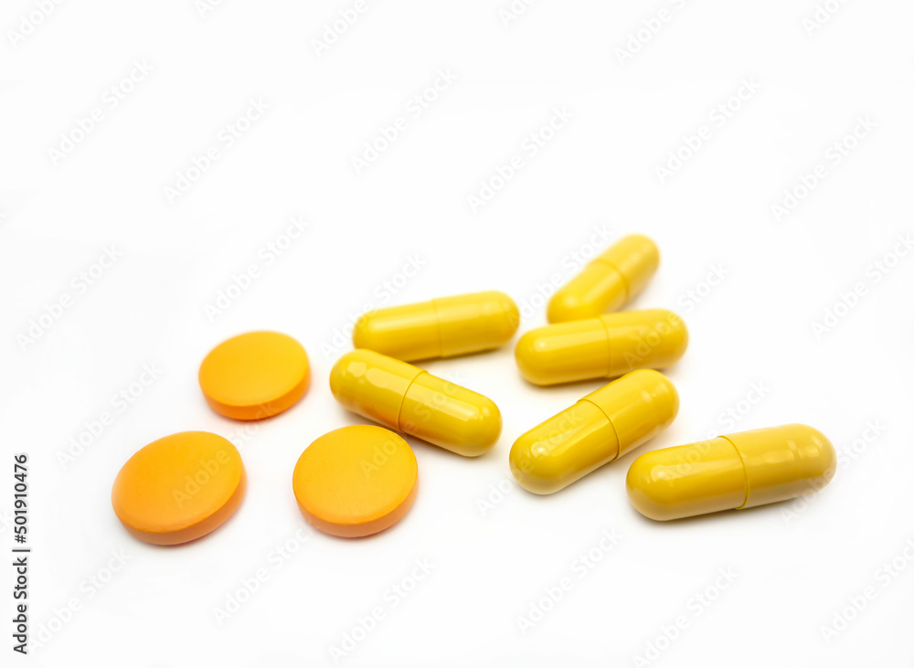Composition with pills on the table. Heap of open medicines on a white paper background. Composition with pills on the table. Heap of open medicines on a white paper background.