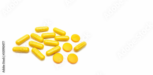 Composition with pills on the table. Heap of open medicines on a white paper background.