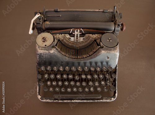 Vintage typewriter on an old brown desk. View from above.