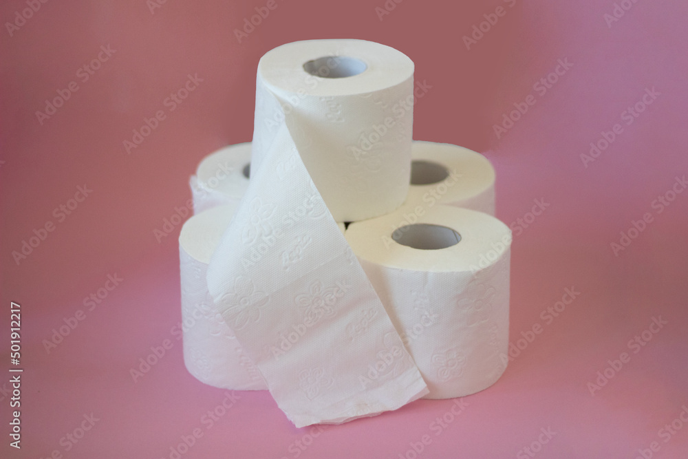 Rolls of white toilet paper on pink background Rolls of white toilet paper on pink background