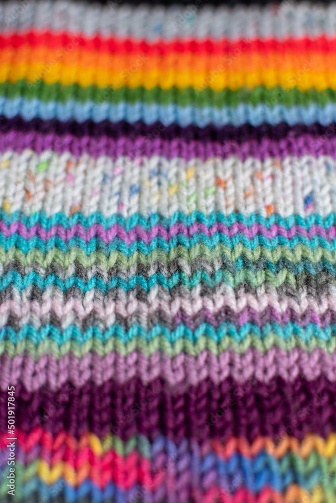 colourful knitting background backdrop with stripes in multi colour and rainbow 