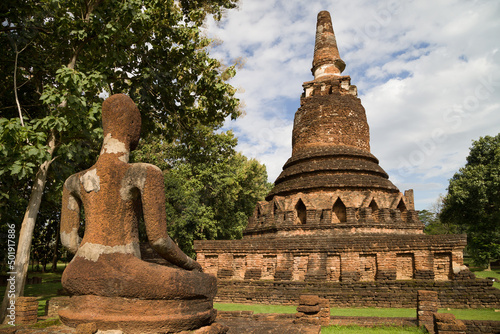 Chedi and Buddha at Wat Phra Kaeo, Kamphaeng Phet, Thailand photo