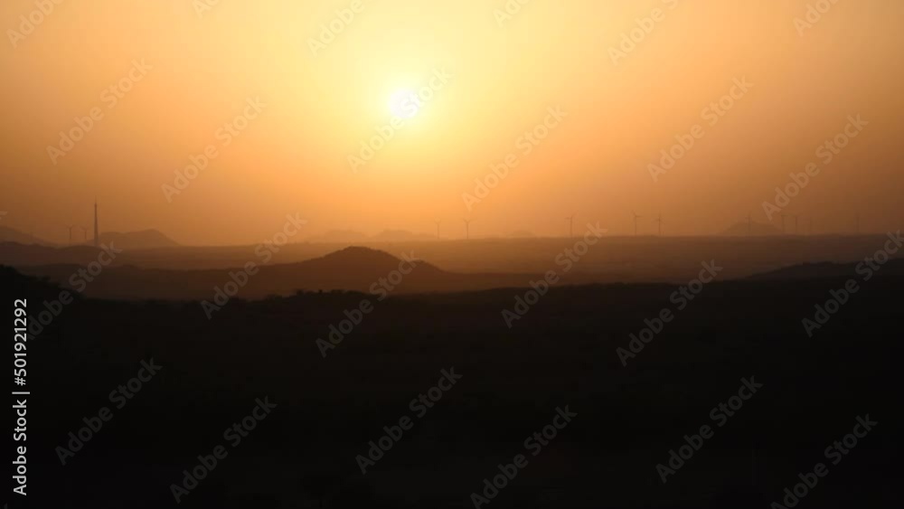 Sunset over layers of hills in Bhuj, Kutch, India. Sun in sky over mountains during evening. Sunset nature landscape. Sunrise in Mountains View Nature Sunset over layers of hills in Bhuj, Kutch, India. Sun in sky over mountains during evening. Sunset nature landscape. Sunrise in Mountains View Nature