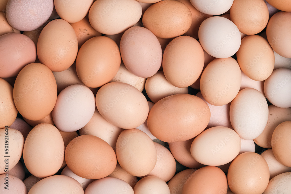 Eggs background. Top view, food background. A lot of organic farm eggs close up. Eggs background. Top view, food background. A lot of organic farm eggs close up.