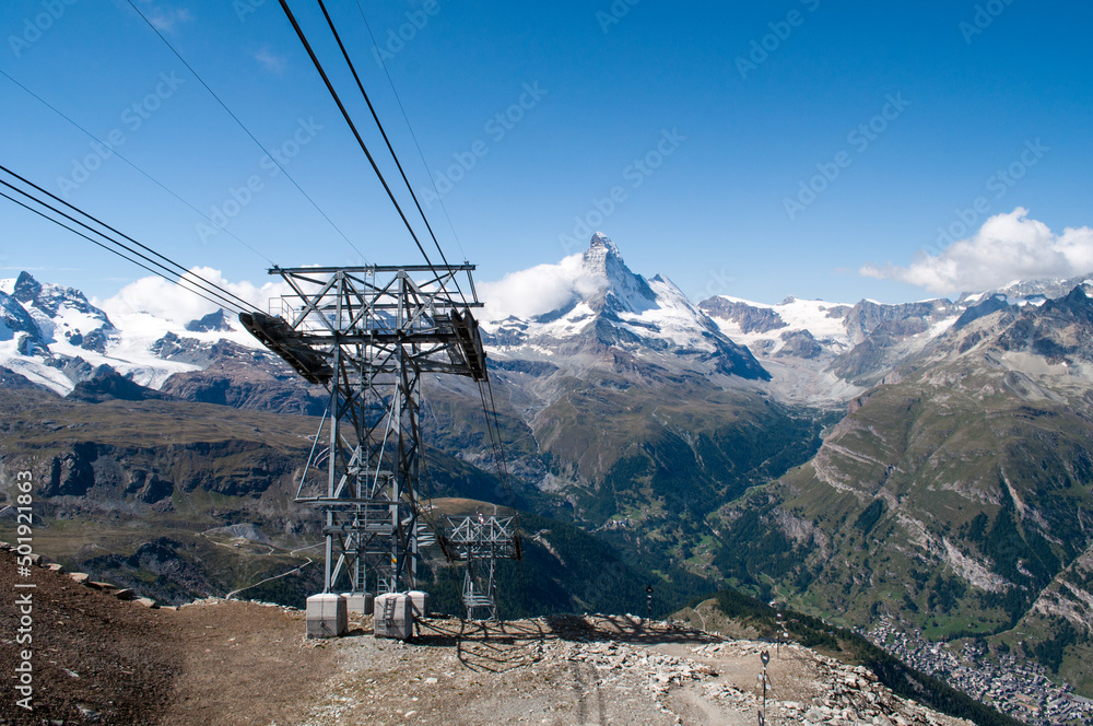 Matterhorn hill in the Swiss Alps with a cable car column. Matterhorn hill in the Swiss Alps with a cable car column.