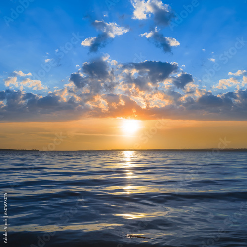 dramatic sunset over the wide lake  beautiful natural water scene