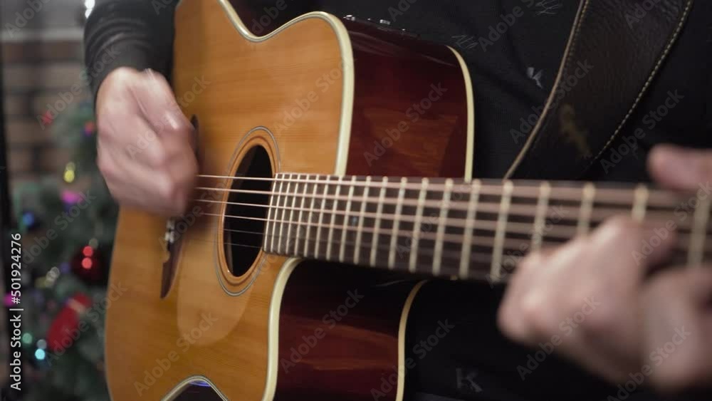 Acoustic guitar in the hands of a musician. The guitarist is playing. Acoustic guitar in the hands of a musician. The guitarist is playing.