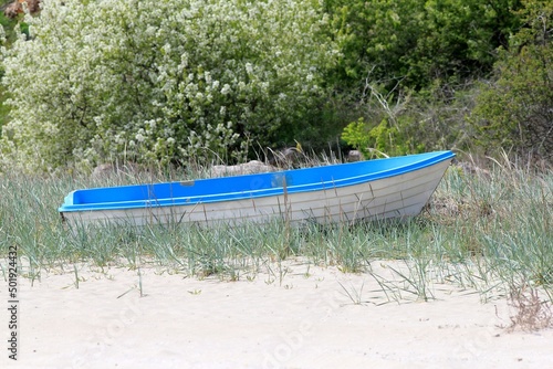 Fishing boat on the sand on the shore of the sea bay