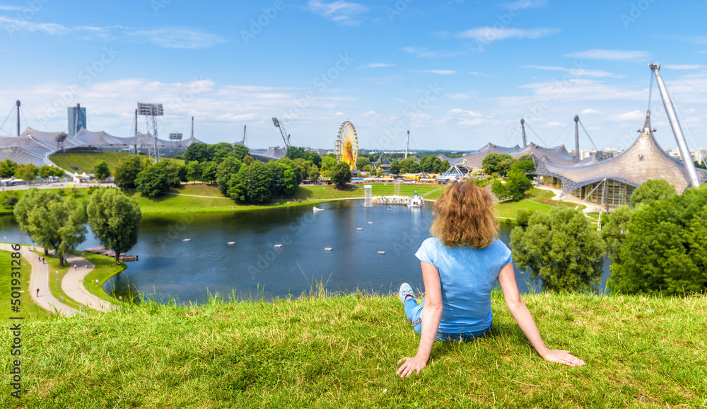Fototapeta premium Girl rests in Olympic Park in summer, Munich, Germany, Europe