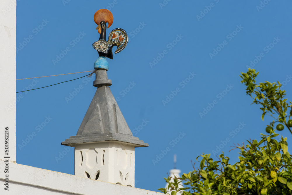 traditional openwork chimney on a roof in Fuseta, Algarve, Portugal..