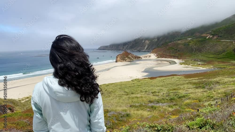Asian woman hiking on one of the may trails in Big Sur on the Pacific Coast of California Asian woman hiking on one of the may trails in Big Sur on the Pacific Coast of California