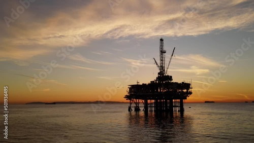 Aerial shot of an offshore oil platform at sunset photo
