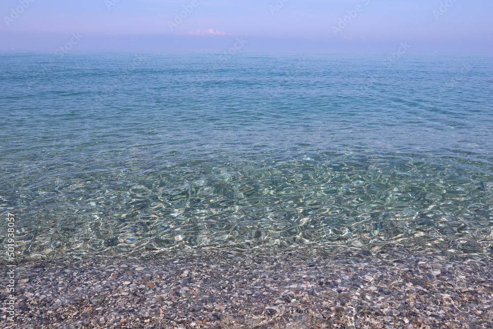 Transparent calm turquoise blue sea, calm, clear blue sky in the early summer morning, Calabria, Italy, background image