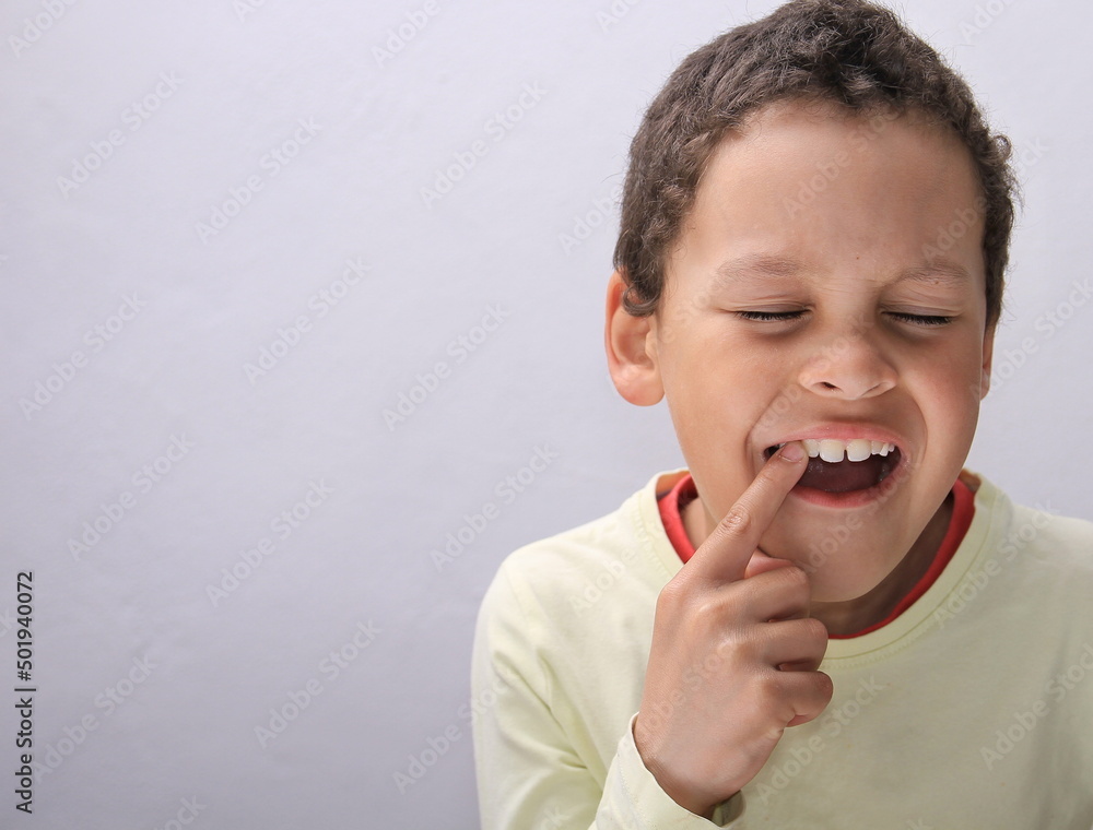 boy with toothache in pain on grey background stock photo boy with toothache in pain on grey background stock photo