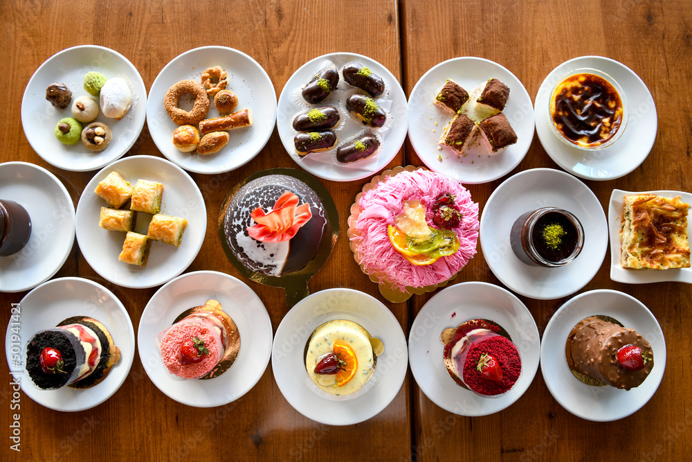 Table scene of assorted take out or delivery foods. Traditional Turkish cuisine. Various Turkish desert and cake. Top down view on a table. Table scene of assorted take out or delivery foods. Traditional Turkish cuisine. Various Turkish desert and cake. Top down view on a table.