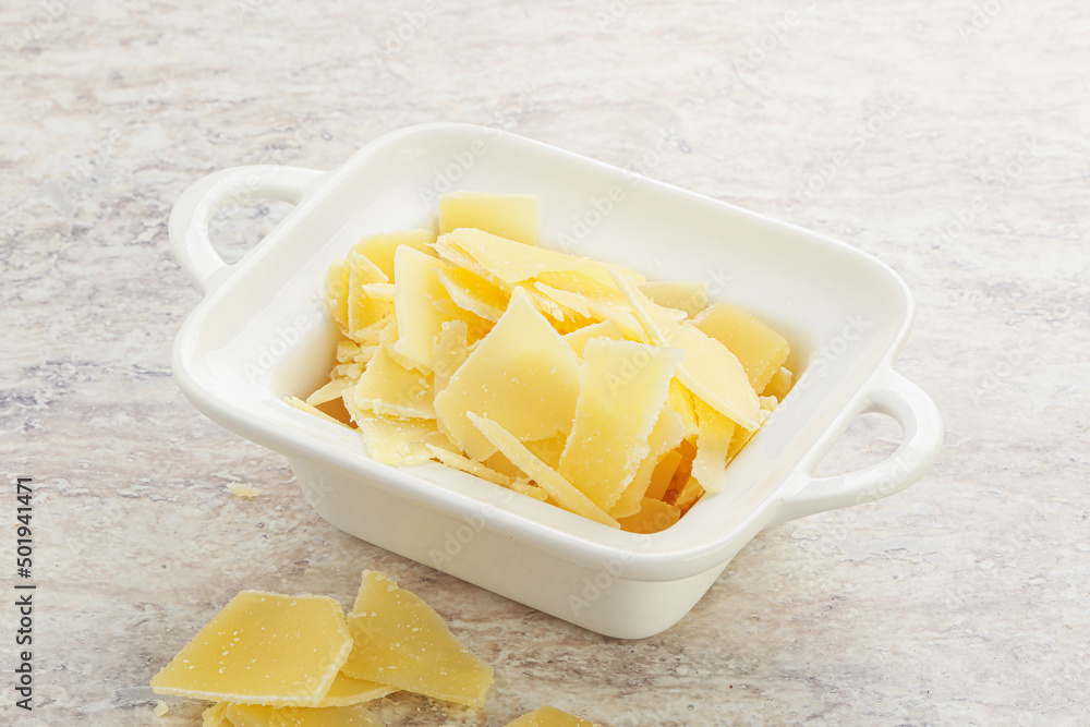 Sliced parmesan cheese heap in the bowl Sliced parmesan cheese heap in the bowl