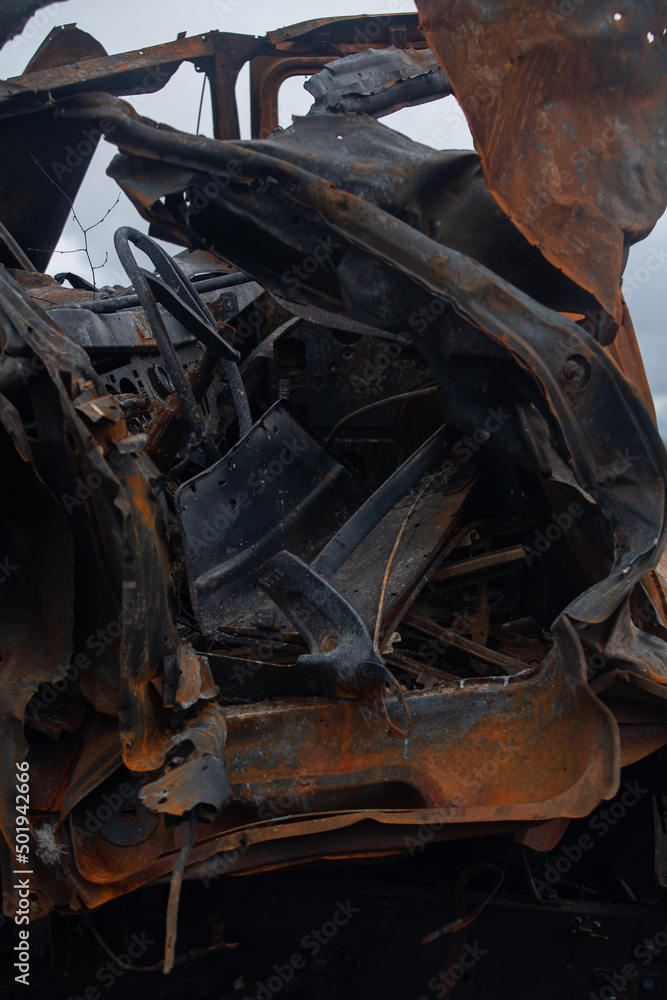 Fototapeta premium Burnt out military vehicle, after being hit by a shell
