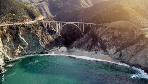 Aerial of the rugged coastline of Big Sur California. The Pacific Coast Highway and the famous Bixby Creek Bridge can be seen.