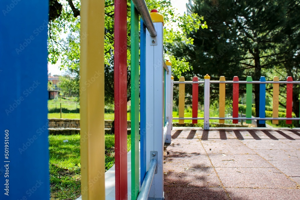 Fence of a colorful children's park with nature background