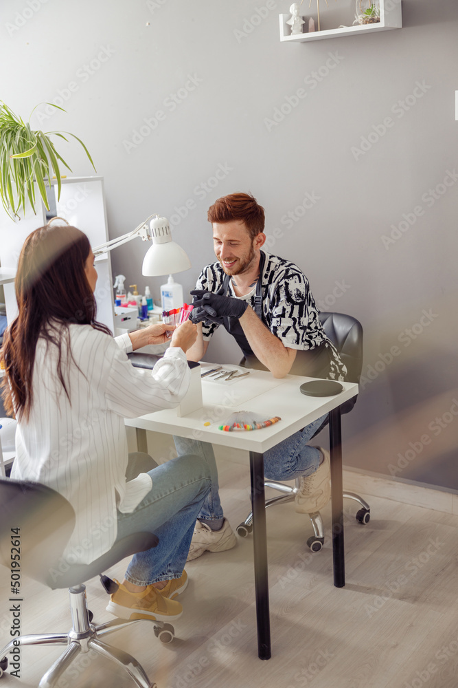 Confident woman having nail manicure in nail art studio Confident woman having nail manicure in nail art studio