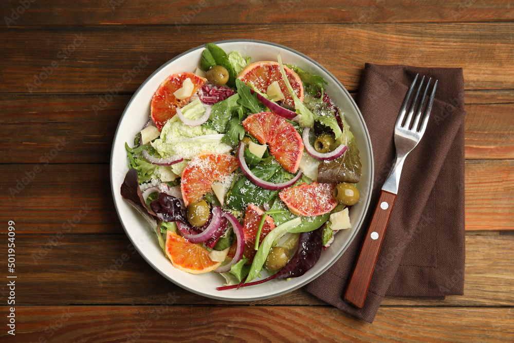 Delicious sicilian orange salad served on wooden table, flat lay