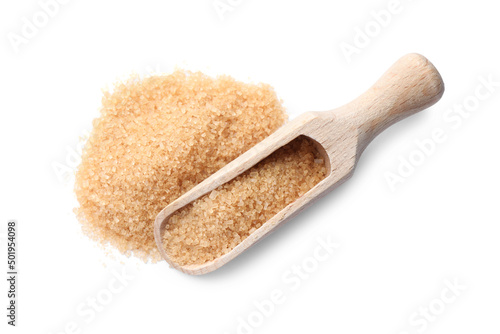 Wooden scoop and brown sugar on white background, top view