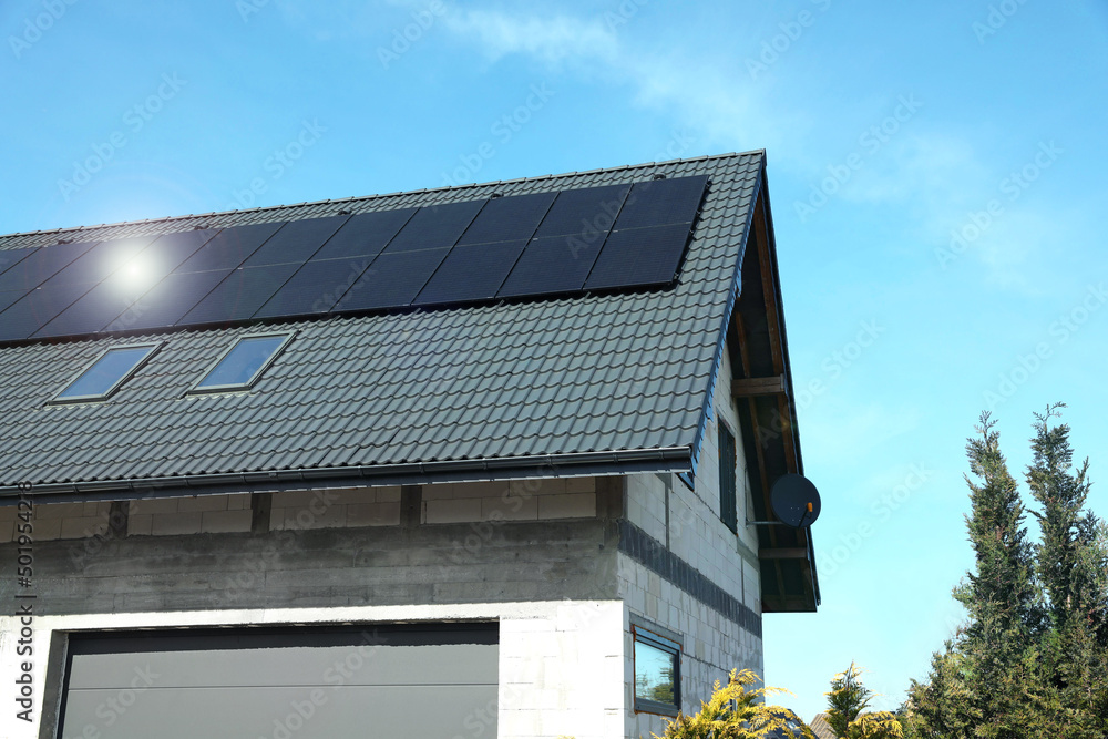 House with installed solar panels on roof. Alternative energy House with installed solar panels on roof. Alternative energy